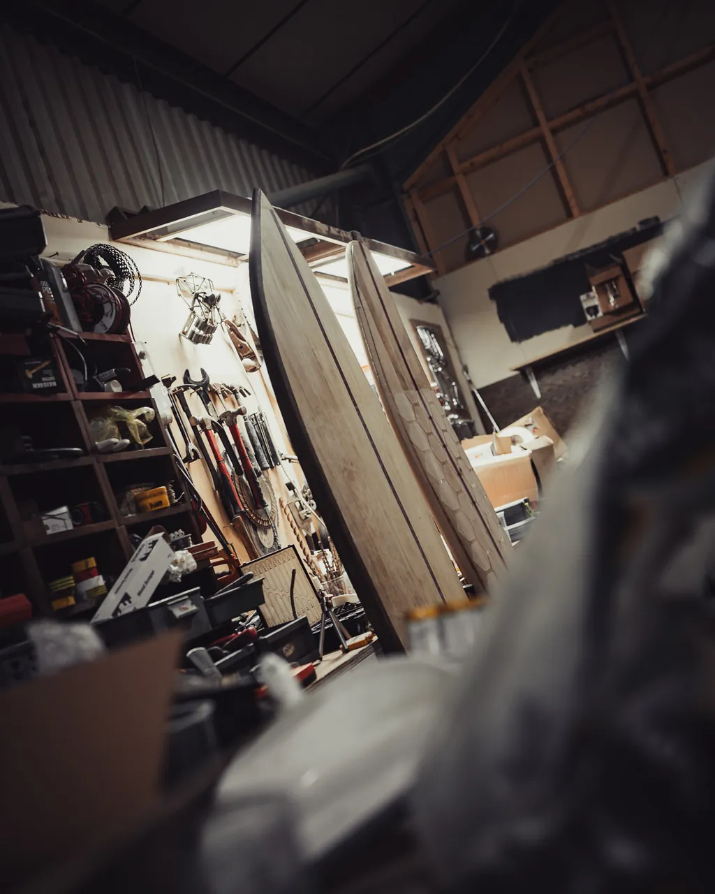 Two boards standing together in the corner of the workshop.